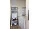 Laundry room featuring a stacked washer and dryer, plus an overhead shelf at 7807 E Main St # F24, Mesa, AZ 85207
