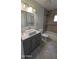 Bathroom with tile flooring, grey vanity, and tile shower at 1116 E 11Th E St, Casa Grande, AZ 85122