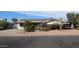 Charming single-story home featuring solar panels, a xeriscaped front yard, and a cozy covered parking area at 1116 E 11Th E St, Casa Grande, AZ 85122