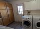 Functional laundry space with washer, dryer, and overhead storage cabinets at 1116 E 11Th E St, Casa Grande, AZ 85122