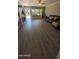 Spacious living room with modern flooring, large windows, and a comfortable seating area at 1116 E 11Th E St, Casa Grande, AZ 85122