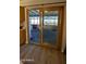 Sunroom with wooden framed glass sliding doors and wood laminate flooring at 1116 E 11Th E St, Casa Grande, AZ 85122