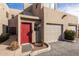 Attractive townhome showcasing a red front door, attached garage and low-maintenance landscaping at 11260 N 92Nd St # 2058, Scottsdale, AZ 85260