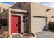 Attractive townhome showcasing a red front door, attached garage and low-maintenance landscaping at 11260 N 92Nd St # 2058, Scottsdale, AZ 85260