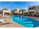 A community pool is surrounded by lounge chairs and lush landscaping at 11260 N 92Nd St # 2058, Scottsdale, AZ 85260