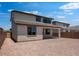 Backyard view with covered patio, tile roof, and gravel landscape at 12219 W Caraveo Pl, Peoria, AZ 85383