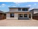 View of backyard with covered patio, neutral color scheme, and tile roof at 12219 W Caraveo Pl, Peoria, AZ 85383