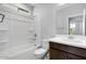 Full bathroom featuring bathtub-shower combo and a single sink with wood cabinets at 12219 W Caraveo Pl, Peoria, AZ 85383