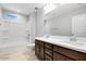 Bathroom features double sinks, tiled floors, and a bathtub-shower combo at 12219 W Caraveo Pl, Peoria, AZ 85383