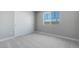 Bedroom featuring soft carpet, neutral walls, a closet and a large window at 12219 W Caraveo Pl, Peoria, AZ 85383