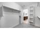 Spacious walk-in closet featuring custom shelving and ample storage space, connecting to bathroom at 12219 W Caraveo Pl, Peoria, AZ 85383