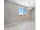 Bright dining area features neutral walls, tile flooring, modern chandelier, and a large window at 12219 W Caraveo Pl, Peoria, AZ 85383