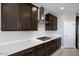 Stylish kitchen with dark cabinets, stainless steel appliances, and plenty of counter space at 12219 W Caraveo Pl, Peoria, AZ 85383