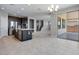 Open-concept kitchen boasts stainless steel appliances, a center island, and seamless flow to the dining area at 12219 W Caraveo Pl, Peoria, AZ 85383