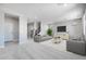 Open-concept living room with neutral tones, plush seating, and ample natural light with stairs in the background at 12219 W Caraveo Pl, Peoria, AZ 85383