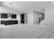 Spacious living room featuring plush carpeting, neutral paint, and seamless flow to the kitchen at 12219 W Caraveo Pl, Peoria, AZ 85383