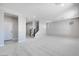 Spacious living room with neutral carpet and an open floor plan leading to the staircase at 12219 W Caraveo Pl, Peoria, AZ 85383
