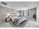 Serene main bedroom with plush bedding, soft lighting, and windows offering natural light at 12219 W Caraveo Pl, Peoria, AZ 85383