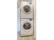 Efficient laundry area featuring a stacked washer and dryer unit, optimizing space and convenience at 12627 N La Montana Dr # 104, Fountain Hills, AZ 85268