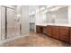 Bathroom featuring a glass shower enclosure, double sink vanity, and walk-in closet entrance at 13110 W Avenida Del Rey --, Peoria, AZ 85383