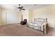 Spacious bedroom featuring a ceiling fan, carpet flooring, and a comfortable sitting area at 13110 W Avenida Del Rey --, Peoria, AZ 85383