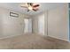 Neutral carpeted bedroom with ceiling fan and two doorways to other areas at 13110 W Avenida Del Rey --, Peoria, AZ 85383