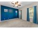 Bedroom features carpet, ceiling fan, two windows, an accent wall, and blue curtains at 13110 W Avenida Del Rey --, Peoria, AZ 85383