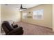 Bright bedroom featuring carpet flooring, a ceiling fan, and large windows at 13110 W Avenida Del Rey --, Peoria, AZ 85383