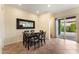Bright dining room featuring a dark wood table, six chairs, a decorative mirror, and sliding glass doors to the patio at 13110 W Avenida Del Rey --, Peoria, AZ 85383