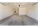 Spacious, empty garage with concrete floor, water heater and lighting at 13110 W Avenida Del Rey --, Peoria, AZ 85383