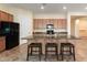 Kitchen island boasts bar seating, sink, and plenty of storage space while featuring neutral paint at 13110 W Avenida Del Rey --, Peoria, AZ 85383