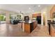 Open concept kitchen featuring an island, breakfast bar, stainless steel appliances, and adjacent living area at 13110 W Avenida Del Rey --, Peoria, AZ 85383