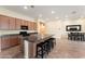 Well-lit kitchen showcasing a large island with seating, ample cabinetry, and a seamless transition to the dining area at 13110 W Avenida Del Rey --, Peoria, AZ 85383