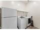 Functional laundry room with a refrigerator, modern washer and dryer, and built-in shelving at 13110 W Avenida Del Rey --, Peoria, AZ 85383