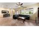Open-concept living space with a large leather sofa, tile flooring, and large windows, perfect for relaxing and entertaining at 13110 W Avenida Del Rey --, Peoria, AZ 85383