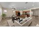 Open-concept living room with modern furnishings seamlessly connects to the dining and kitchen areas at 13110 W Avenida Del Rey --, Peoria, AZ 85383