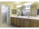 Well-lit bathroom featuring double sinks and a large mirror over a wooden vanity at 1325 E Brent Ct, Casa Grande, AZ 85122