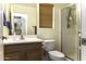 Bright bathroom featuring a glass shower, wood blinds, and a wood vanity at 1325 E Brent Ct, Casa Grande, AZ 85122