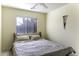 Cozy bedroom with a ceiling fan, window with blinds, neutral walls, and comfortable bedding for a restful retreat at 1325 E Brent Ct, Casa Grande, AZ 85122