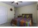 Neutral bedroom with a ceiling fan and a colorful quilt on the bed at 1325 E Brent Ct, Casa Grande, AZ 85122