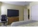 Cozy bedroom featuring a large TV, comfortable chair, and a neutral color palette at 1325 E Brent Ct, Casa Grande, AZ 85122