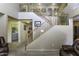 Welcoming entryway with a staircase leading to a second level and adjacent laundry room for added convenience at 1325 E Brent Ct, Casa Grande, AZ 85122