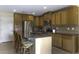 Functional kitchen with a center island, stainless steel refrigerator, ample counter space, and wood cabinets at 1325 E Brent Ct, Casa Grande, AZ 85122