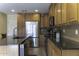 Spacious kitchen features stainless steel appliances, a center island, and rich wood cabinetry for style and functionality at 1325 E Brent Ct, Casa Grande, AZ 85122