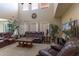 Spacious living room with high ceilings, large windows, comfortable leather seating, and stylish decor at 1325 E Brent Ct, Casa Grande, AZ 85122
