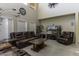 Bright living room with high ceilings, large windows, comfortable seating, and a large screen television at 1325 E Brent Ct, Casa Grande, AZ 85122
