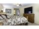 Well-lit main bedroom with a large television, wooden dresser, and a cozy bed at 1325 E Brent Ct, Casa Grande, AZ 85122