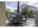 Outdoor brick patio with dining set, umbrella, and built-in grill is perfect for entertaining at 1325 E Brent Ct, Casa Grande, AZ 85122