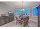 Casual dining area with a round glass table and a storage cabinet that also holds the tv at 15004 W Home Run Dr, Surprise, AZ 85374