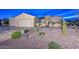 Charming single-story home with a well-maintained yard, desert landscaping, and a spacious two-car garage at 15004 W Home Run Dr, Surprise, AZ 85374